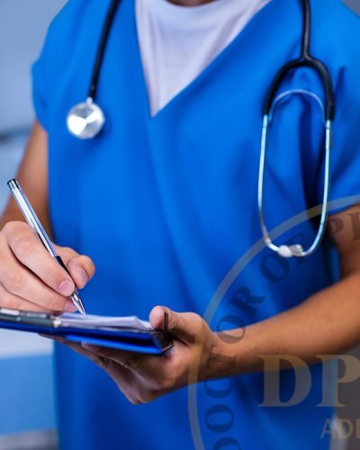 Mid section of nurse writing on clipboard in ward at hospital